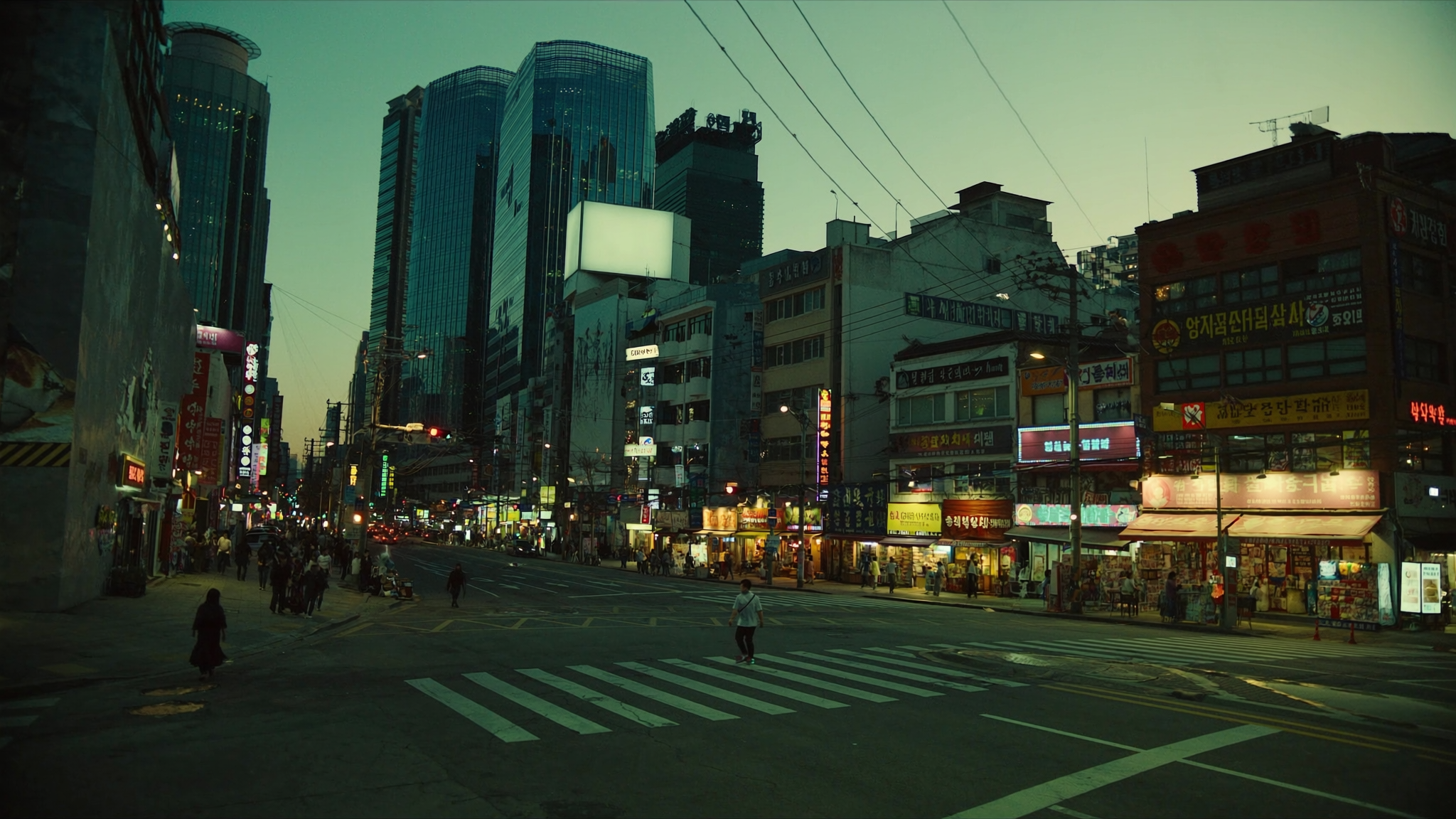 A vibrant Seoul street at night lined with Korean convenience stores