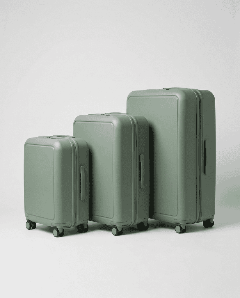 Three hard-shell suitcases compared by height: a 20-inch carry-on, a 24-inch medium checked bag, and a 28-inch large checked bag